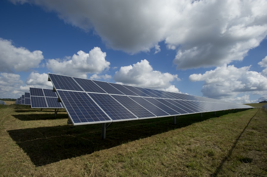 Distesa di pannelli fotovoltaici sotto un cielo con nuvole